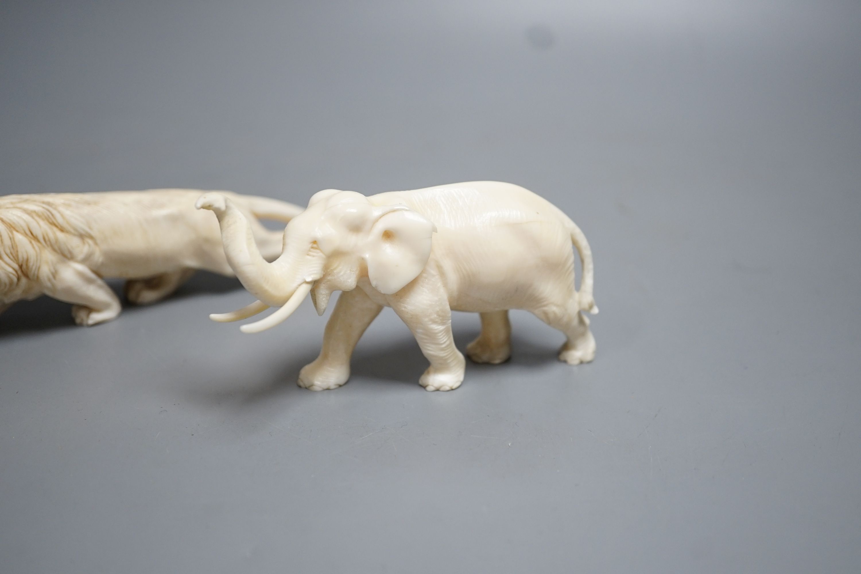 A Japanese Ivory model of an elephant and a similar Ivory model of a lion, early 20th century (2) lion 17cm long